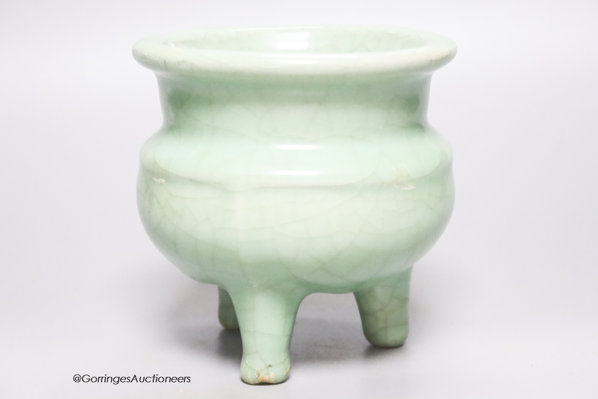 A Chinese green crackle glazed tripod censer, height 12cm